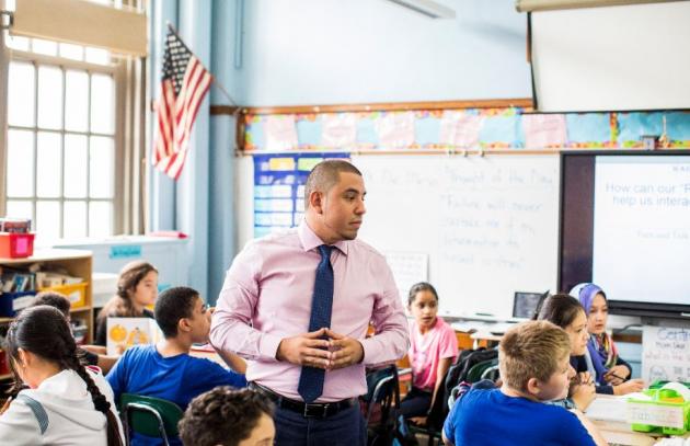 A teacher in a classroom, New York City (USA)